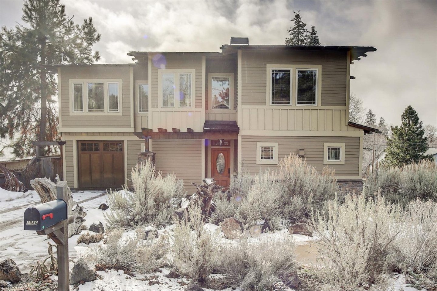 Modern Northwest style home with red front door and desert landscaping, 9th St, Central Oregon