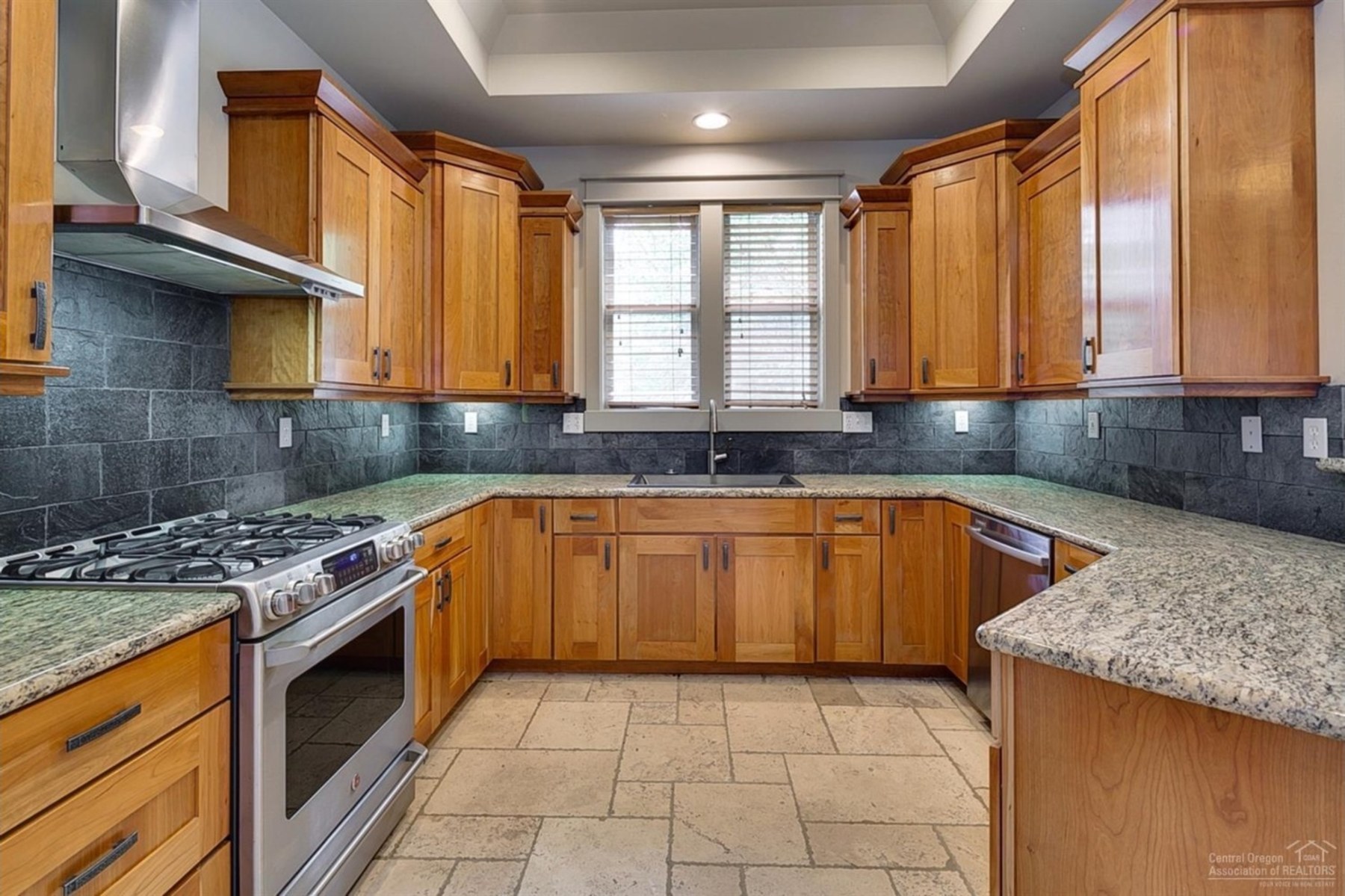 Kitchen with wood cabinetry and island seating, Baltimore Ave, Central Oregon