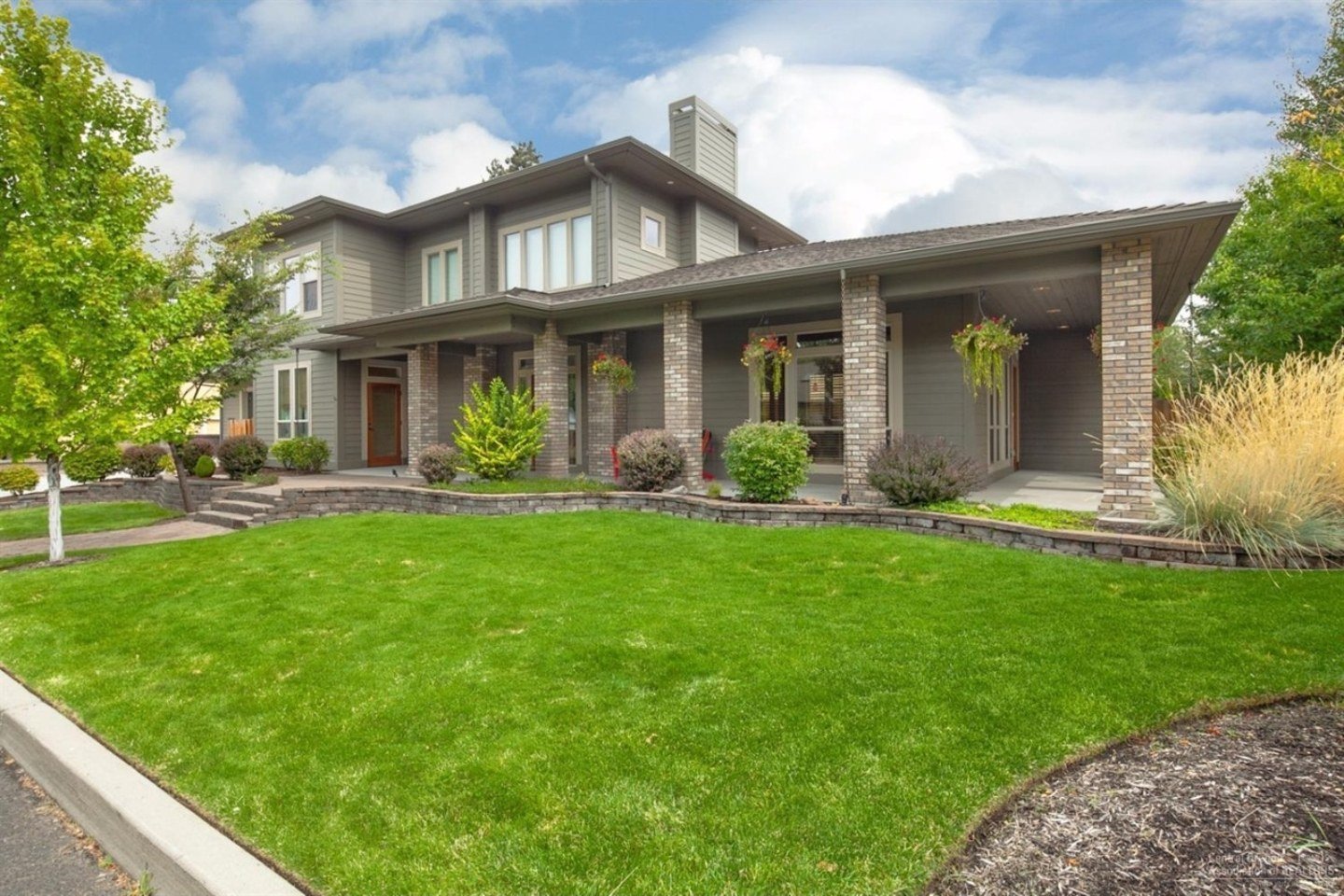Modern Northwest style home with covered porch and stone accents, Baltimore Ave, Central Oregon